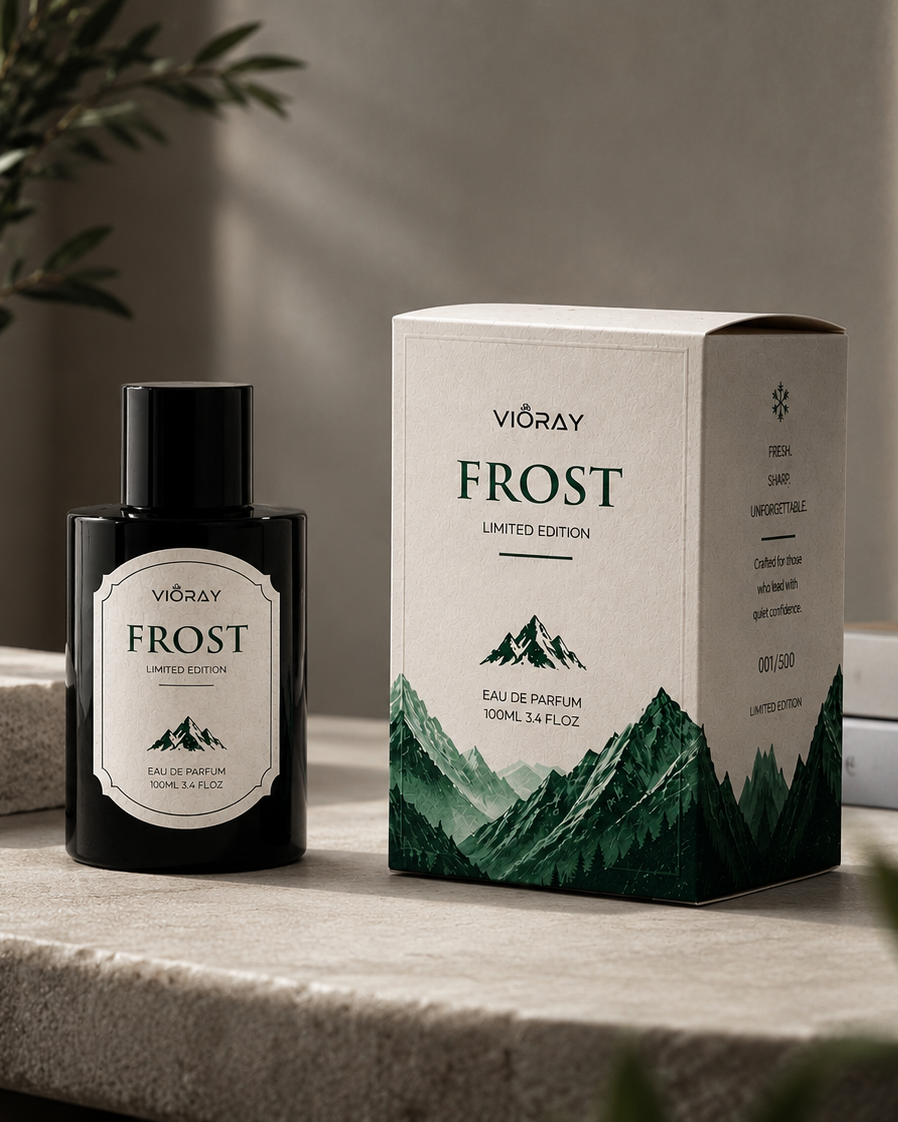 Vioray Frost perfume bottle and packaging on a stone surface with plants in the background