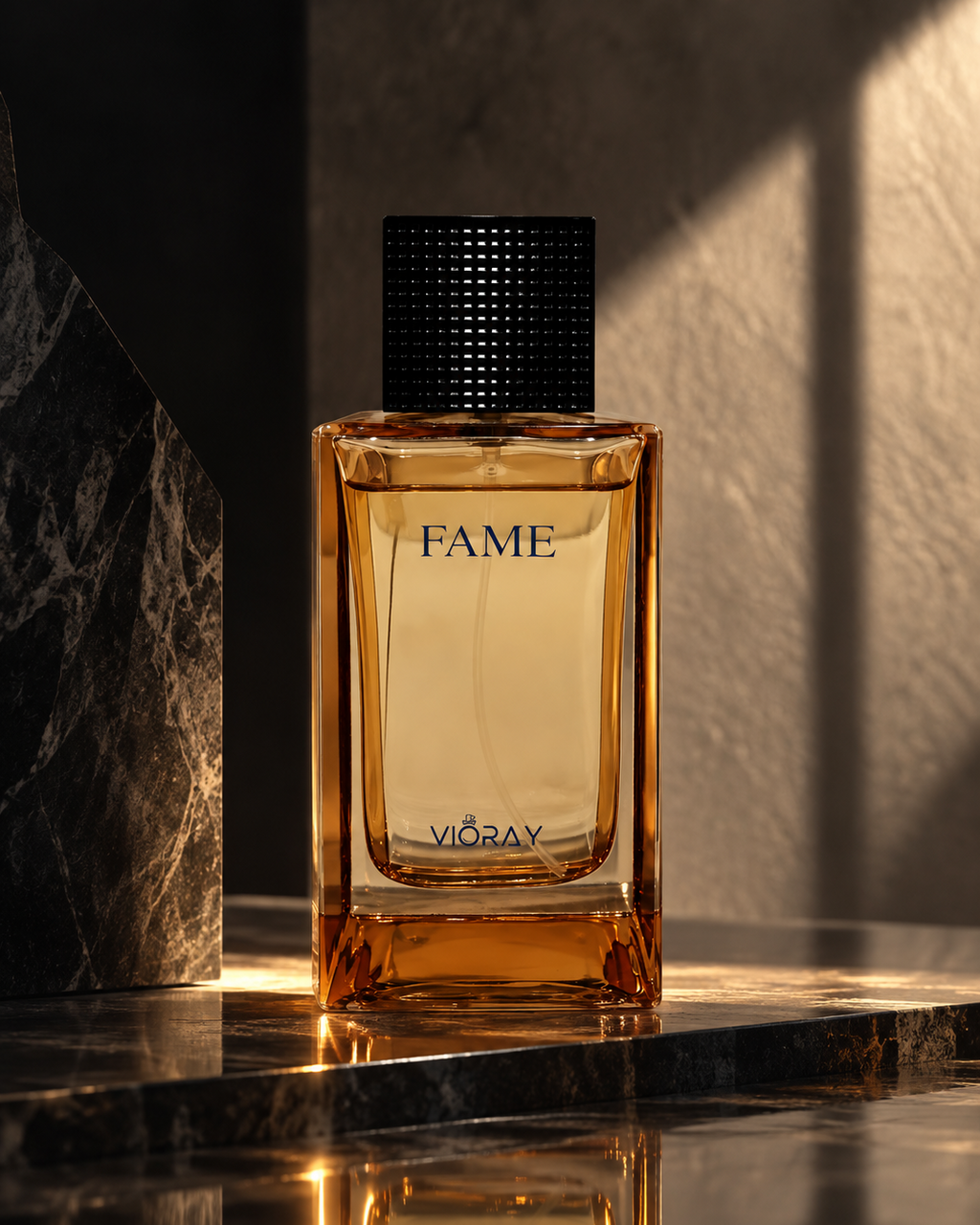 A rectangular amber glass fragrance bottle with a black textured cap, labeled FAME and VIKAVYI, standing on a polished dark marble surface with dramatic warm lighting and shadows.